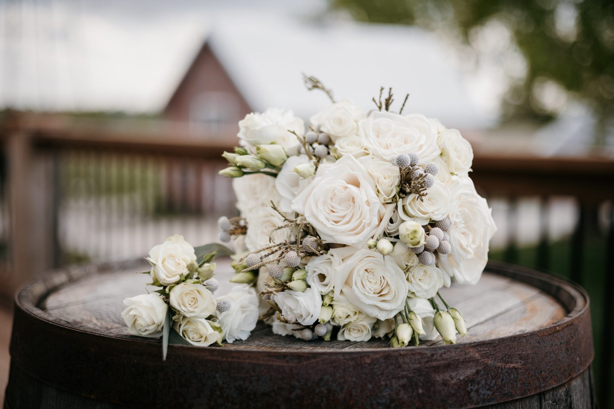 Bouquet of white flowers on a wooden barrel with a blurred background